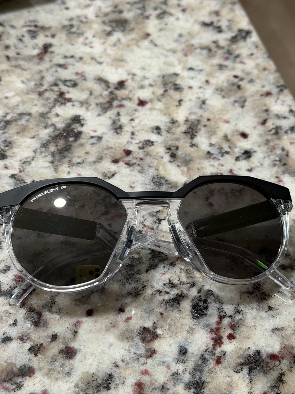 Oakley Clear Frame Sunglasses with Black Top Rim and Dark Lenses
